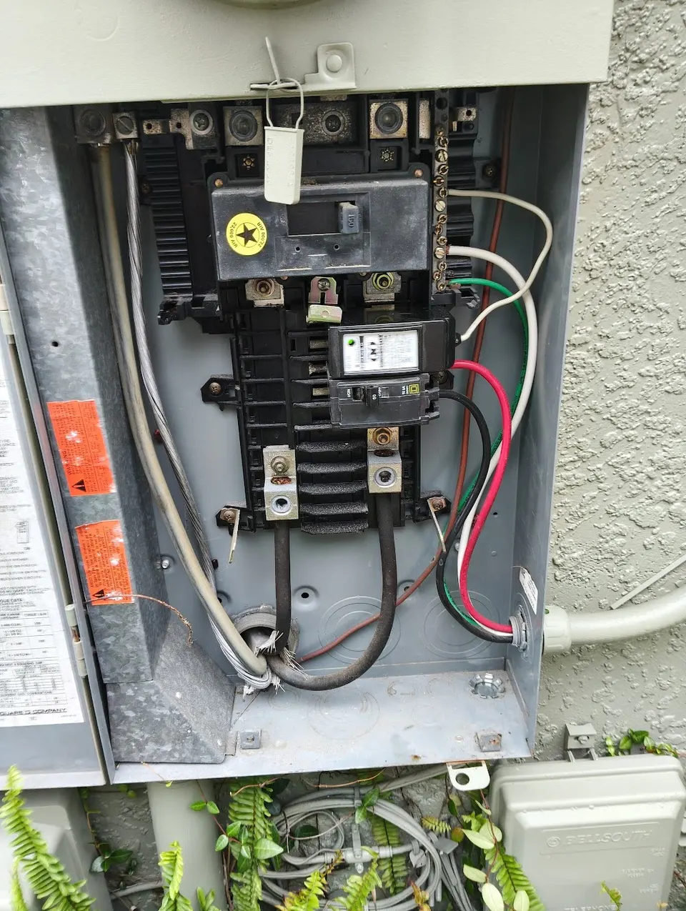 Whole-home surge protector installed beside an electrical panel in Central Florida