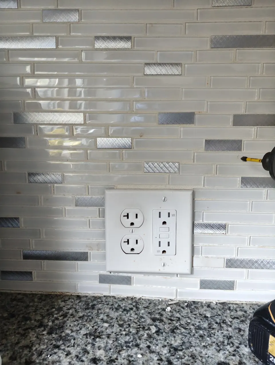 New tamper-resistant outlet installed on a wall by In Phaze Electric
