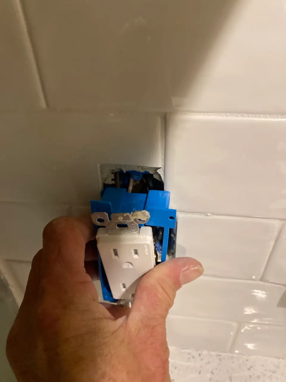 Electrician reworking branch circuits during a rewire in an older Orlando home